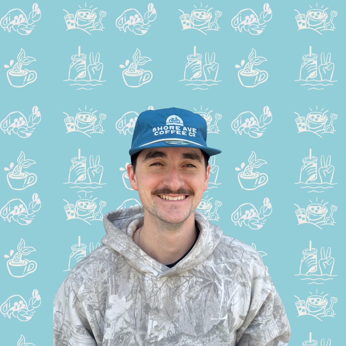 Person wearing a cap and hoodie against a blue background with white patterns